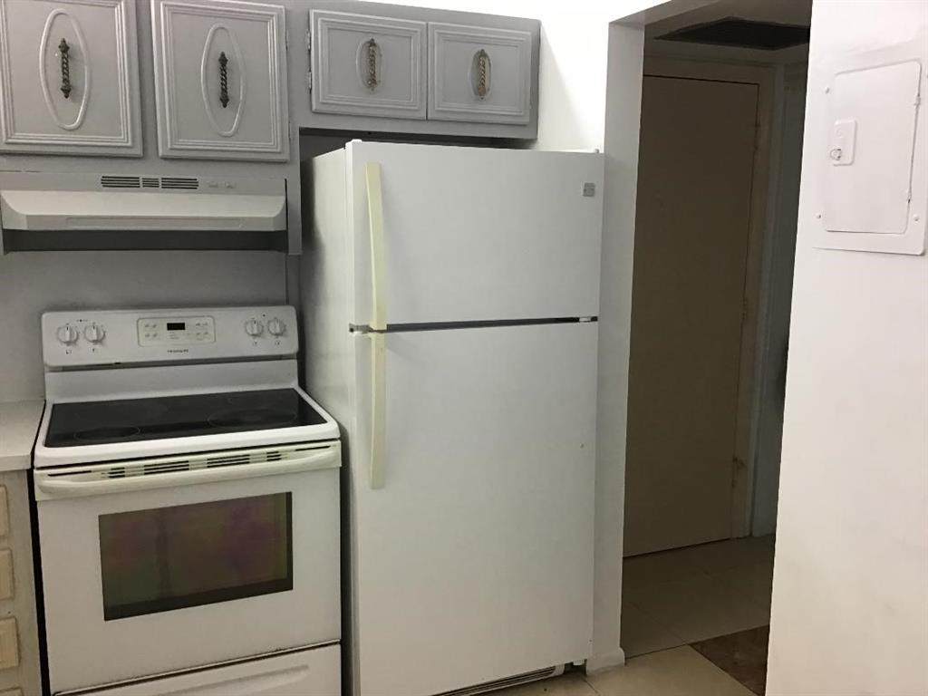 5641 Southwest 2nd Court, Unit 212 Margate, FL 33068 - Photo 2 of 18 a white refrigerator freezer and a stove sitting inside of a kitchen