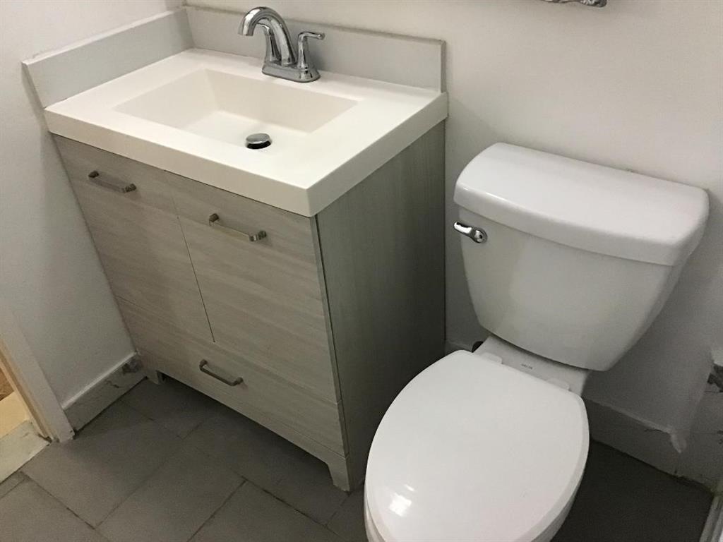 5641 Southwest 2nd Court, Unit 212 Margate, FL 33068 - Photo 8 of 18 a bathroom with a toilet sink and mirror