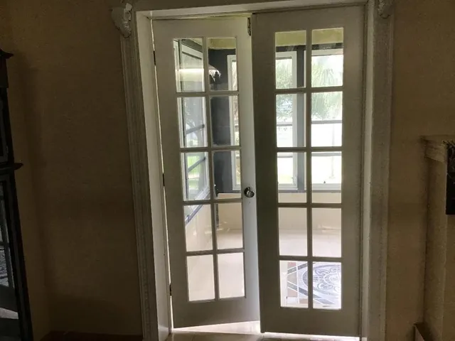 a view of a room with a large window and an outdoor view