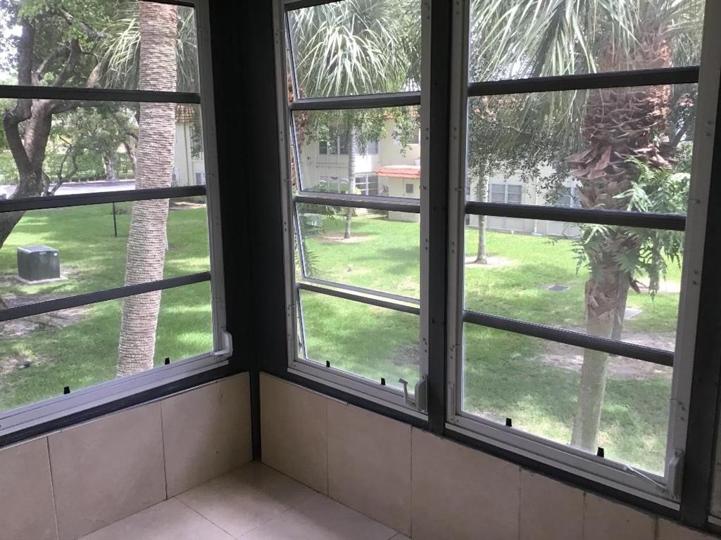 5641 Southwest 2nd Court, Unit 212 Margate, FL 33068 - Photo 10 of 18 a view of a room with a large window and an outdoor view
