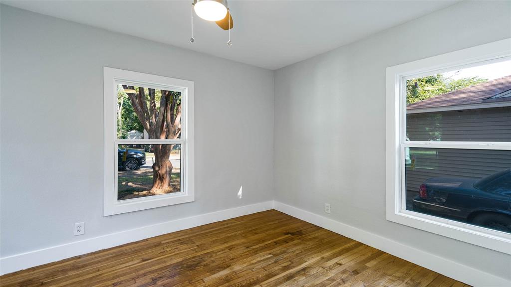 10523 Newcombe Drive Dallas, TX 75228 - Photo 12 of 25 a view of an empty room with wooden floor and a window
