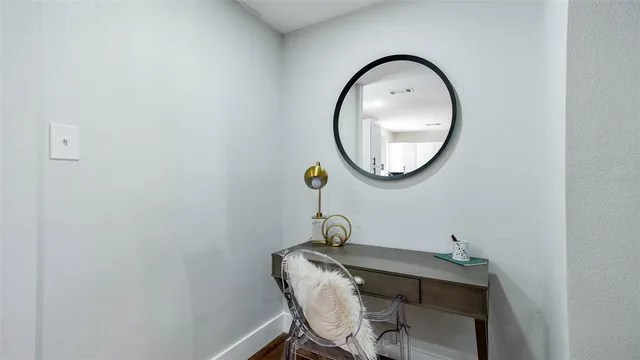 a view of a mirror with wooden floor