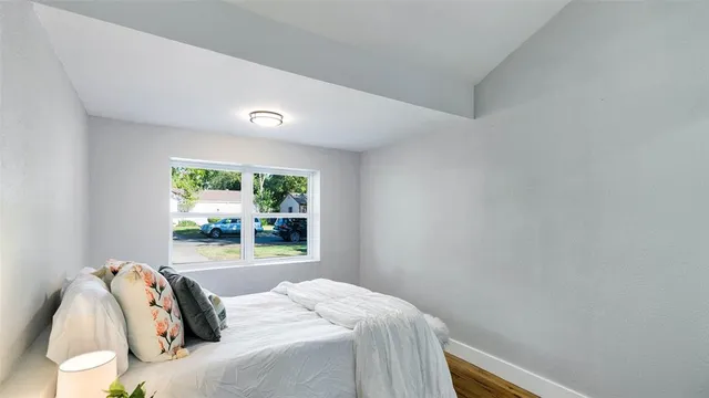 a bedroom with a bed and a window