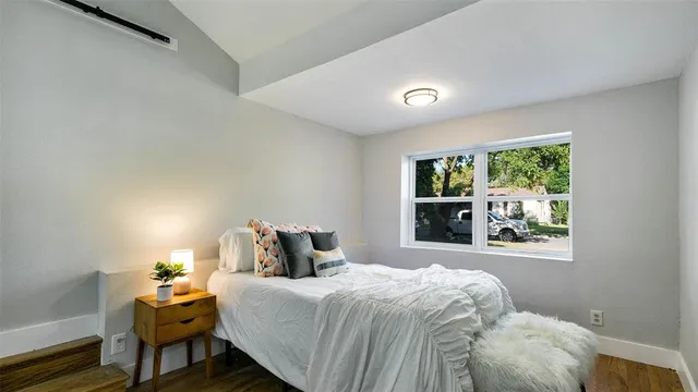 a bedroom with a bed and window