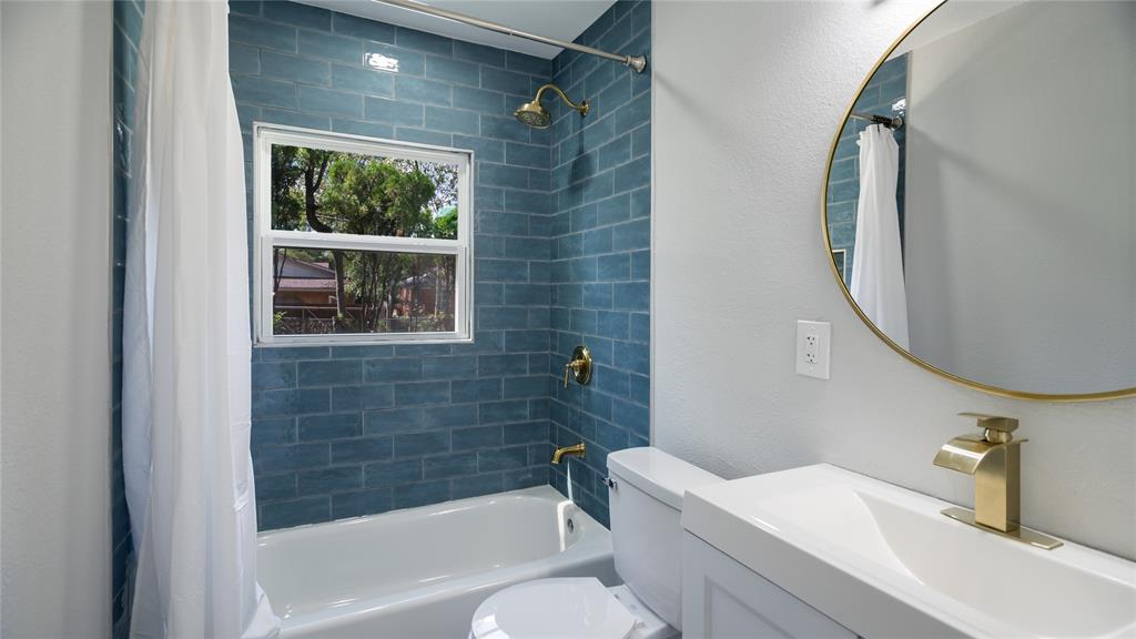 10523 Newcombe Drive Dallas, TX 75228 - Photo 23 of 25 a bathroom with a sink a toilet and shower