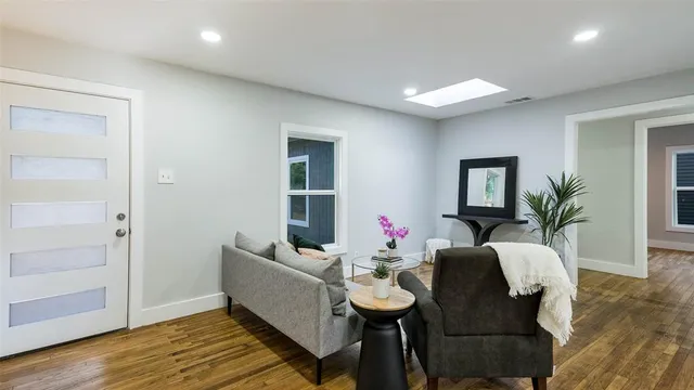 a living room with furniture and wooden floor