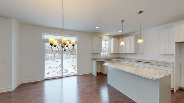 a large kitchen with lots of counter space wooden floor and appliances