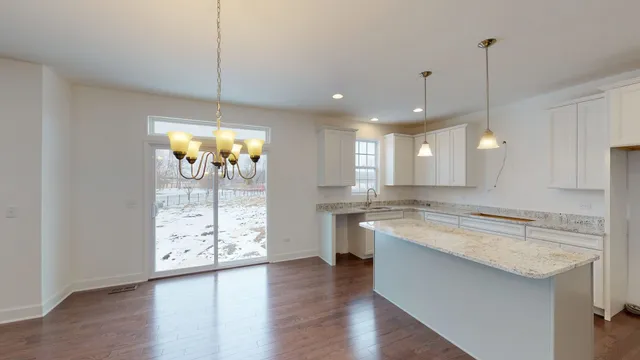 a large kitchen with lots of counter space wooden floor and appliances