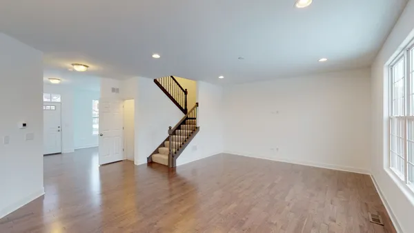 a view of entryway with wooden floor and stairs