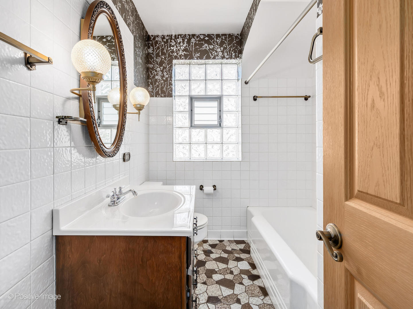 2216 14th Avenue North Riverside, IL 60546 - Photo 12 of 24 a bathroom with a sink a toilet and a window