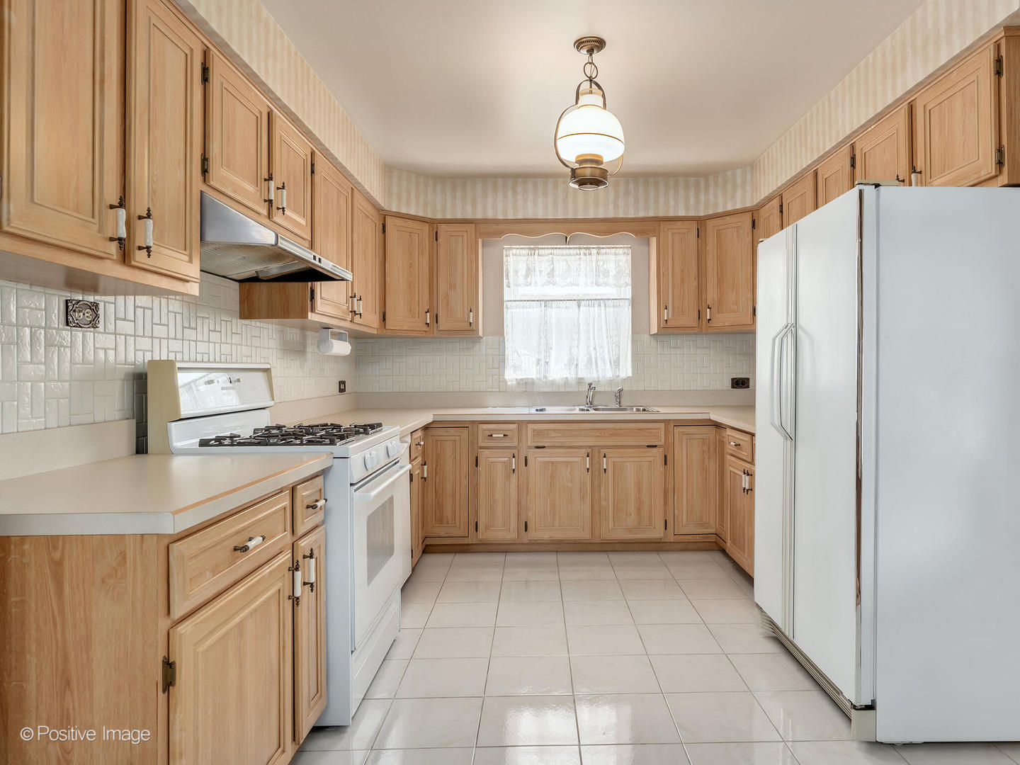 2216 14th Avenue North Riverside, IL 60546 - Photo 7 of 24 a kitchen with stainless steel appliances granite countertop a refrigerator sink and cabinets