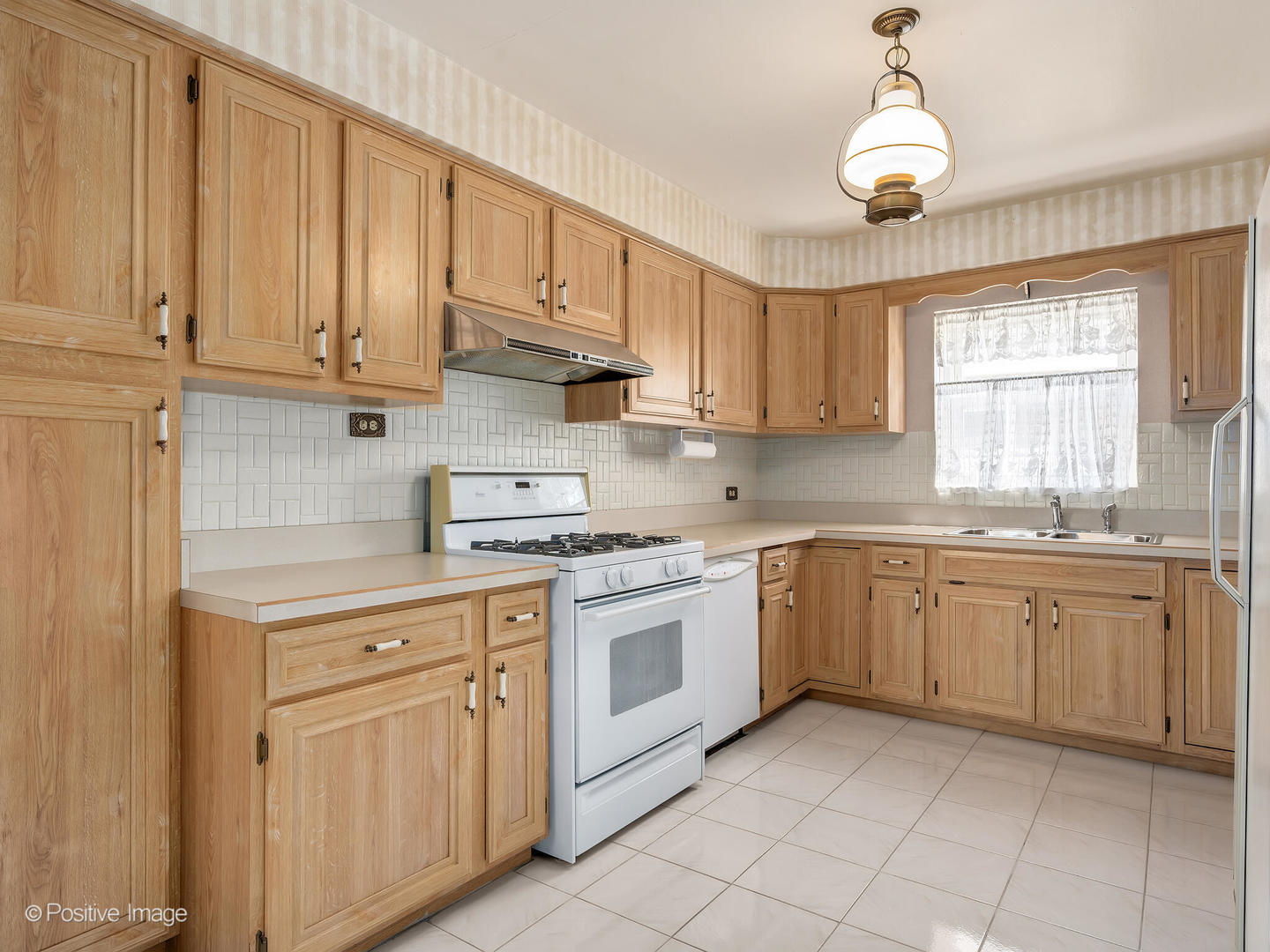 2216 14th Avenue North Riverside, IL 60546 - Photo 8 of 24 a kitchen with white cabinets and white appliances