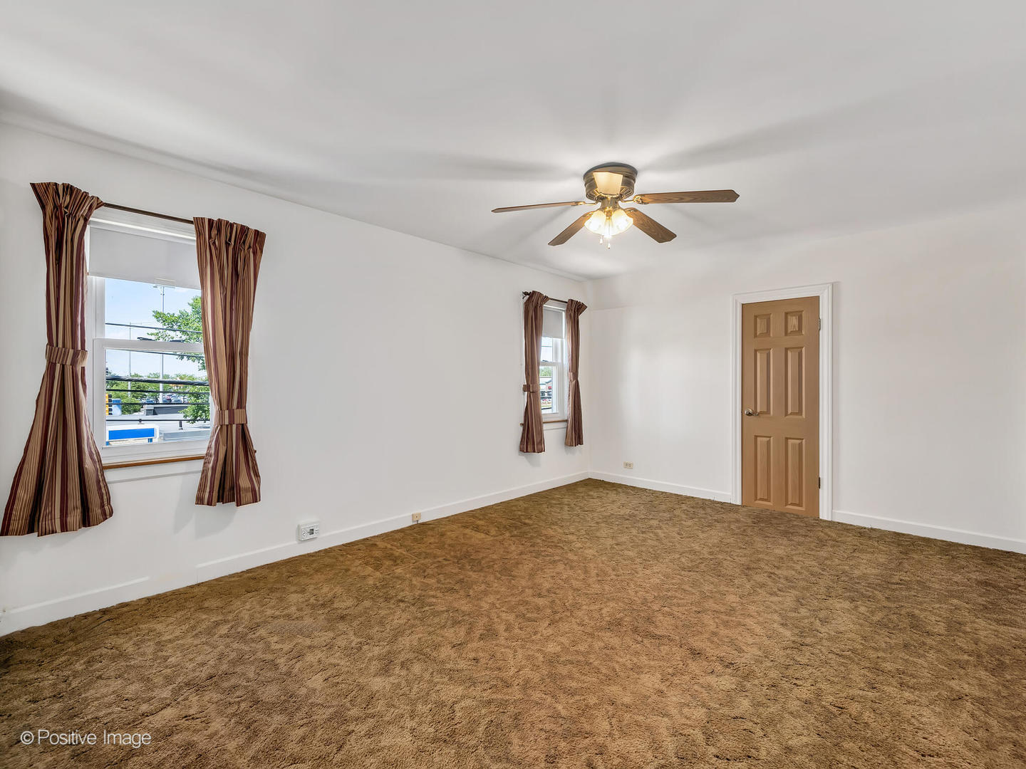 2216 14th Avenue North Riverside, IL 60546 - Photo 10 of 24 a view of an empty room with window and a ceiling fan