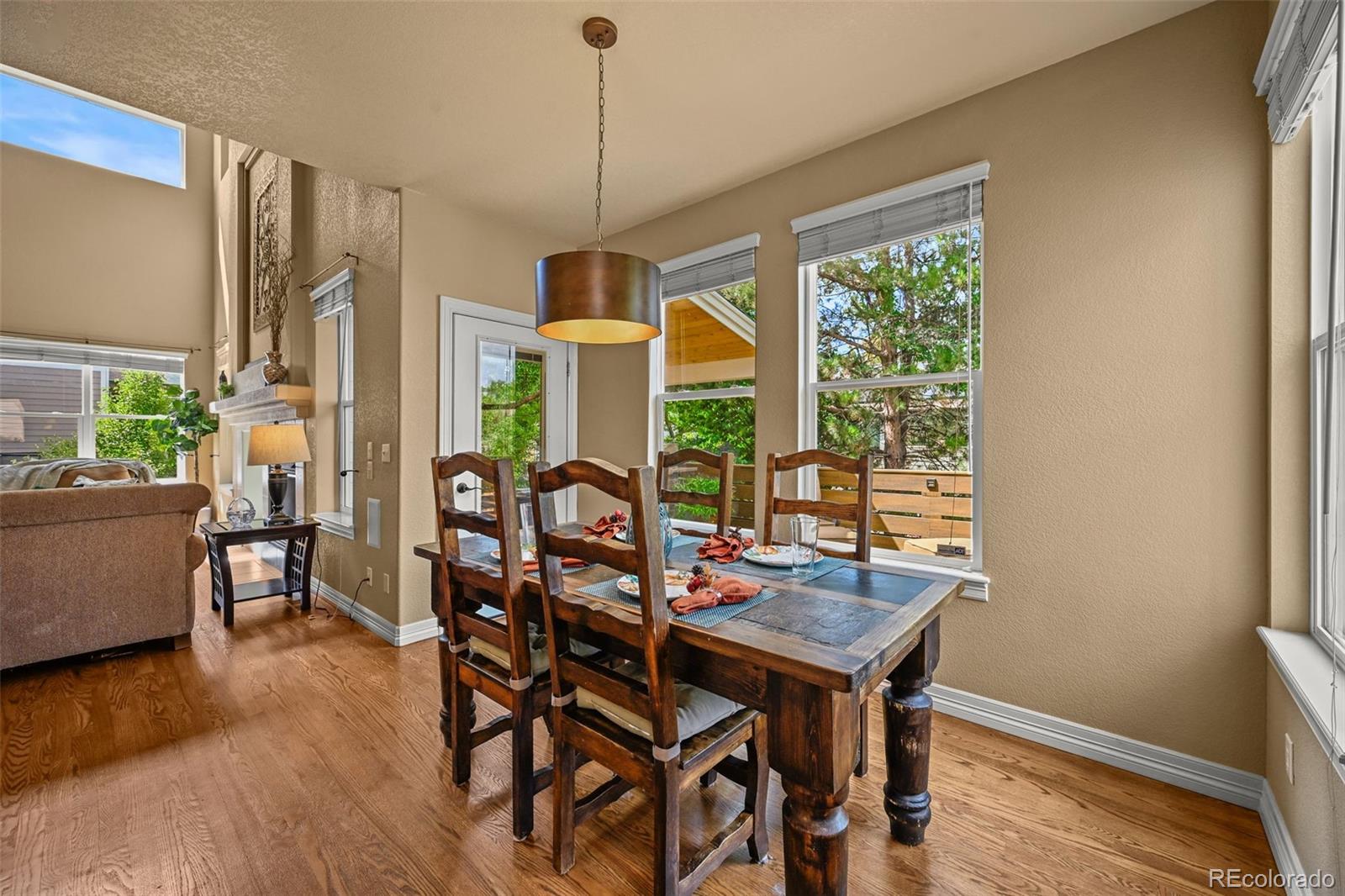 10123 Mockingbird Lane Highlands Ranch, CO 80129 - Photo 19 of 45 a view of a dining room with furniture window and wooden floor