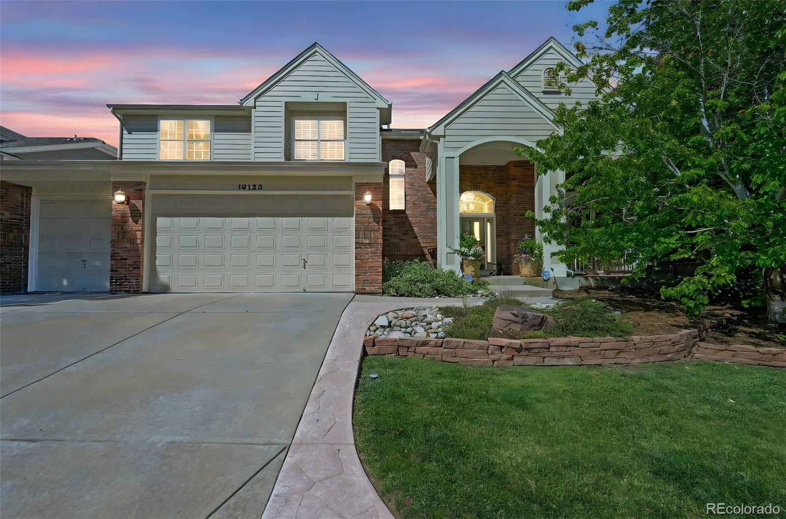 10123 Mockingbird Lane Highlands Ranch, CO 80129 - Photo 2 of 45 a front view of a house with a yard