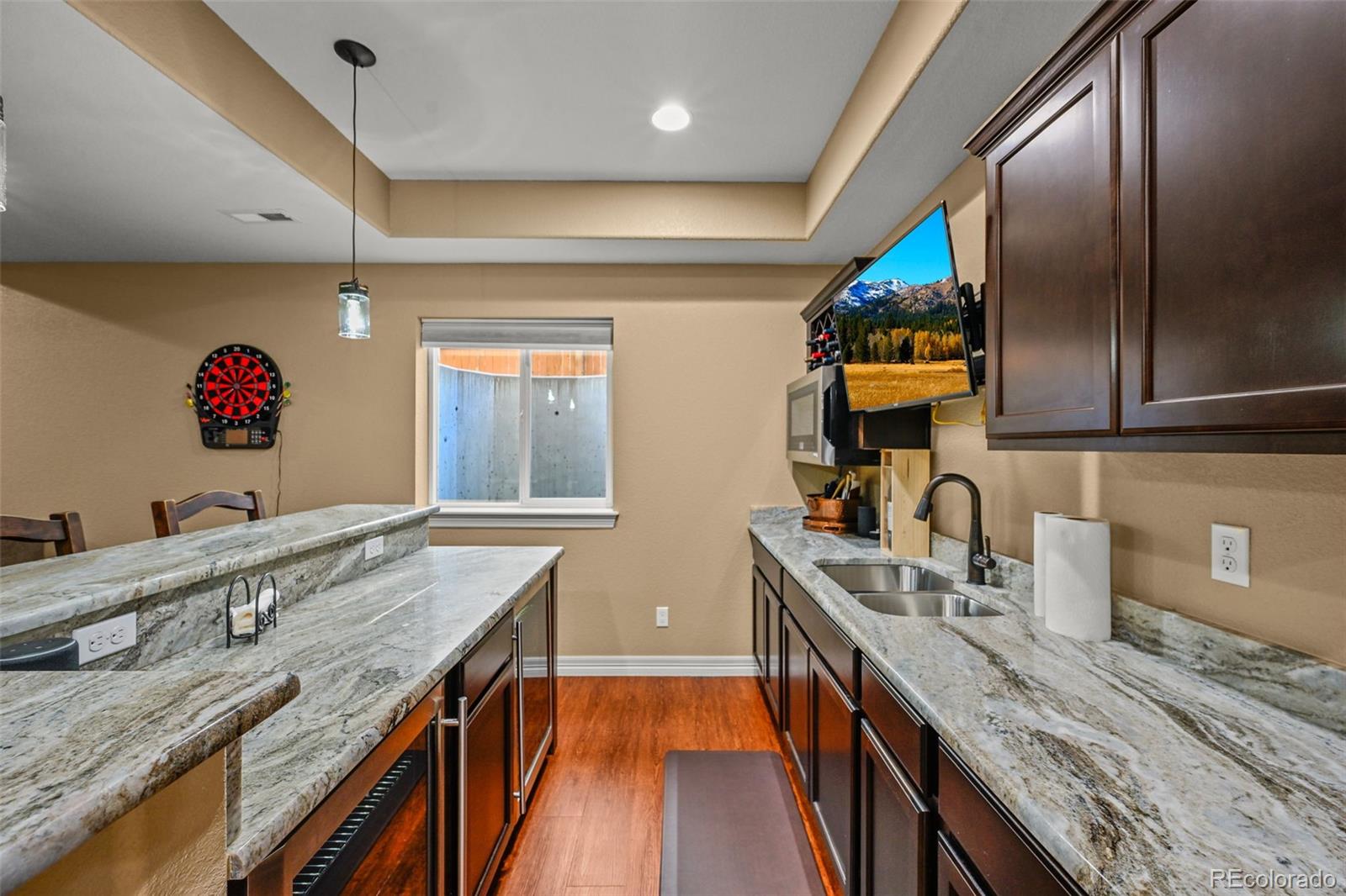10123 Mockingbird Lane Highlands Ranch, CO 80129 - Photo 8 of 43 a kitchen with granite countertop stainless steel appliances a sink stove and cabinets