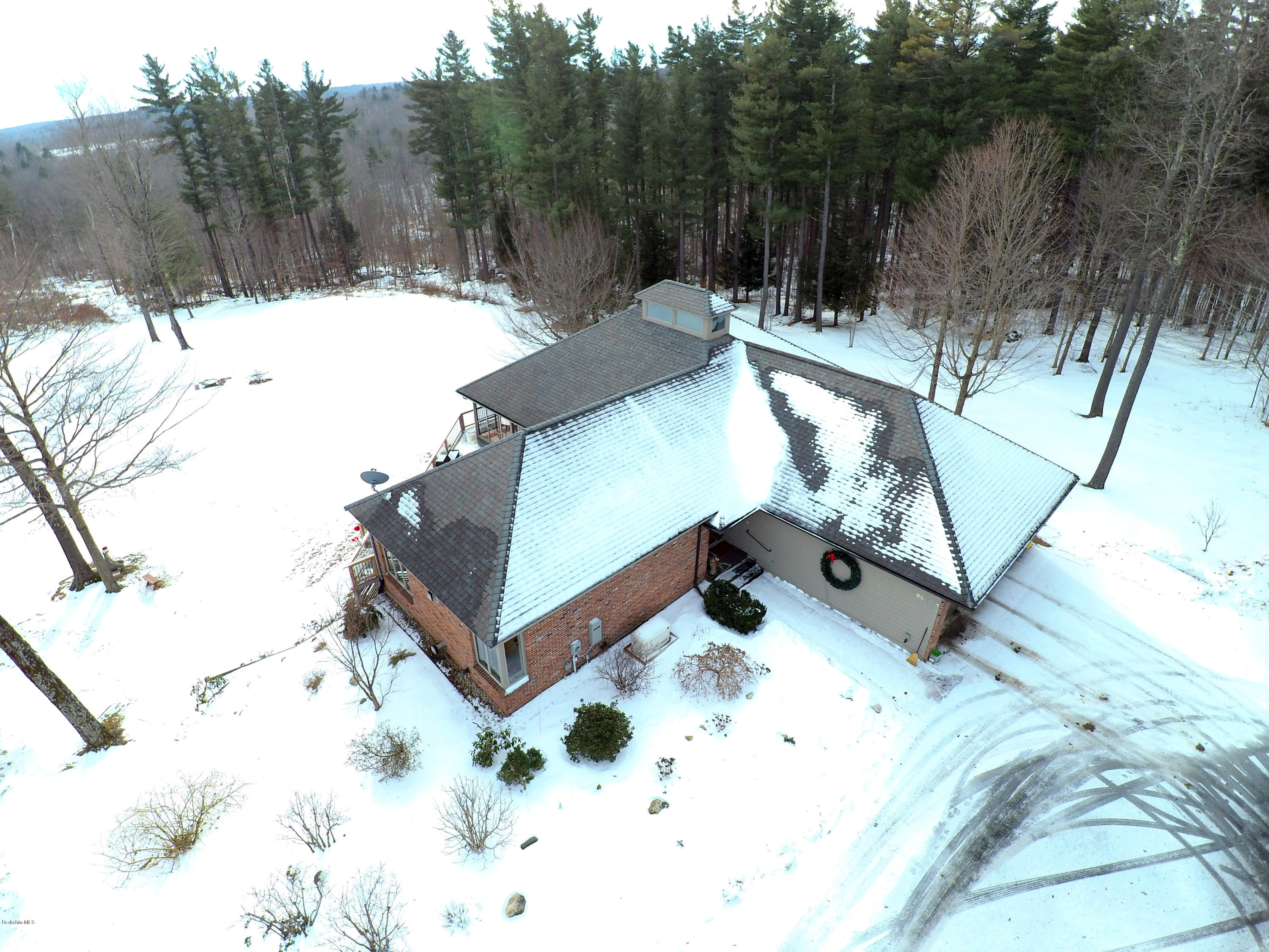 98 Ridge Road Worthington, MA 01098 - Photo 14 of 16 a view of a backyard with snow on the road