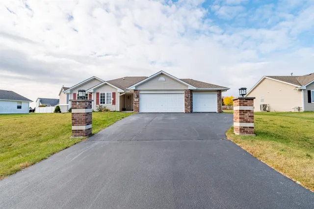 a front view of house with yard and car parked