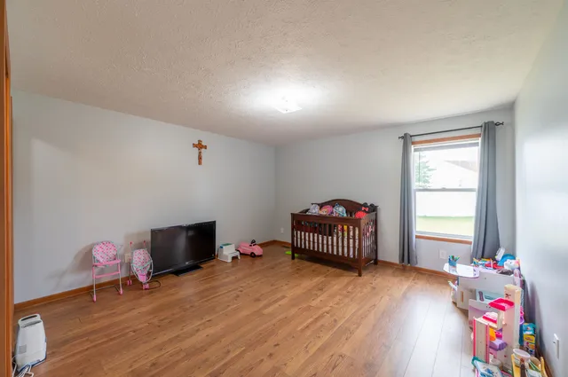 a bedroom with furniture and a window