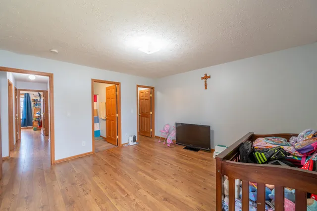 a bedroom with furniture and wooden floor