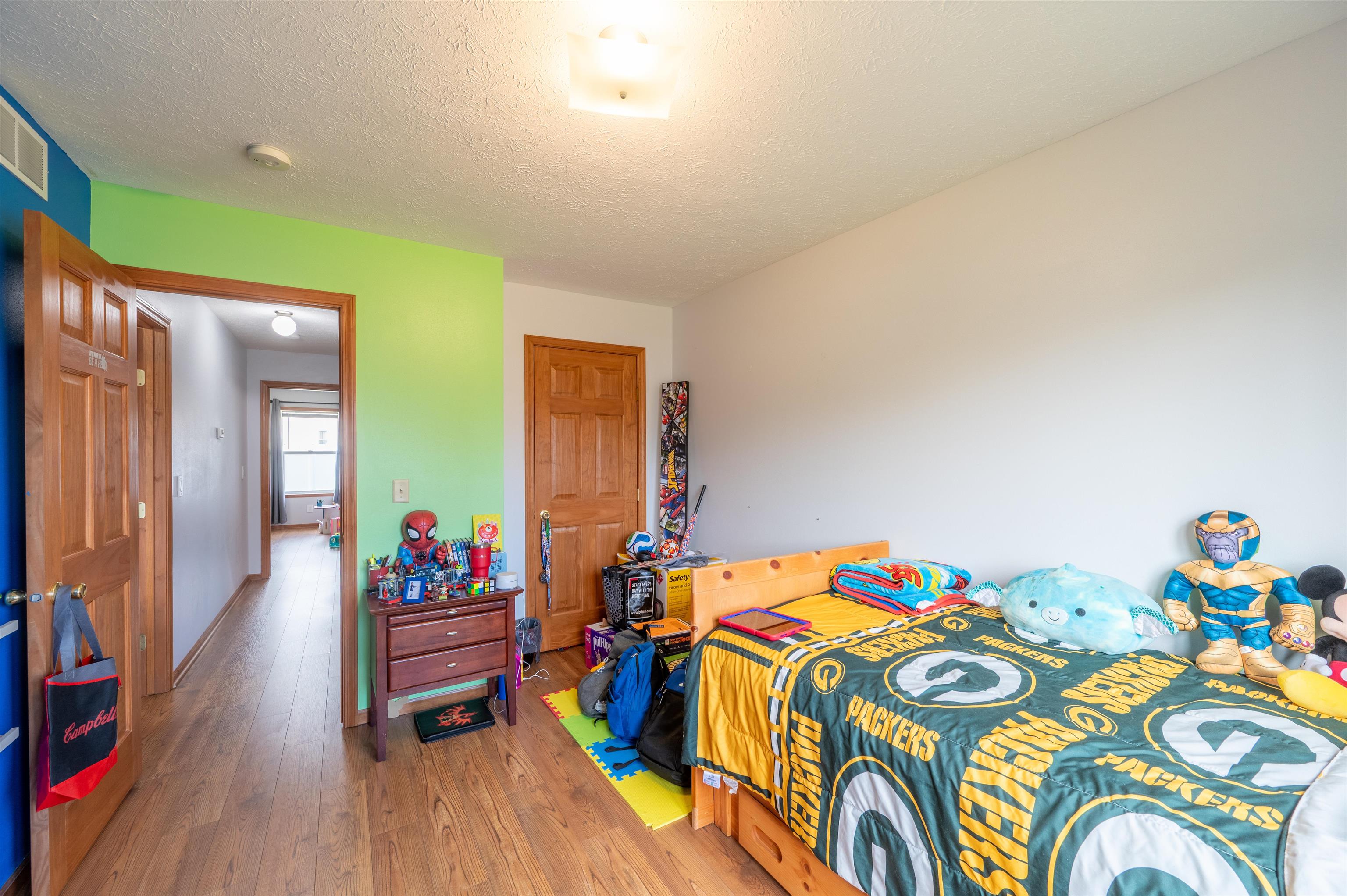 726 Golden Prairie Drive Davis Junction, IL 61020 - Photo 19 of 29 a bedroom with a bed and a wooden floor