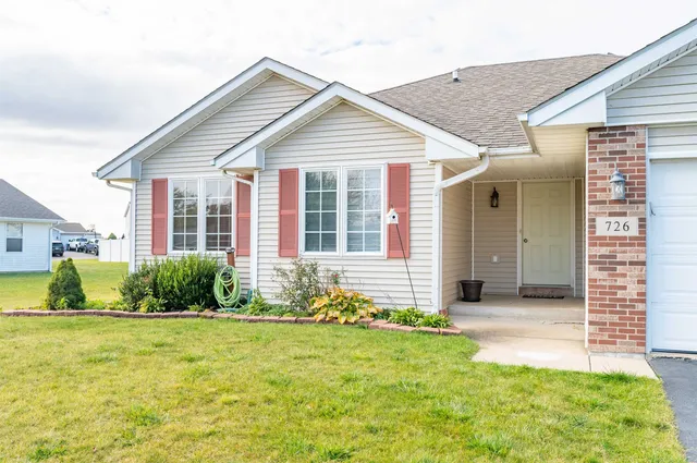 a front view of a house with a yard