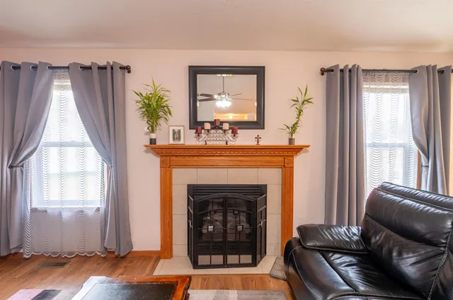a living room with furniture and a fireplace