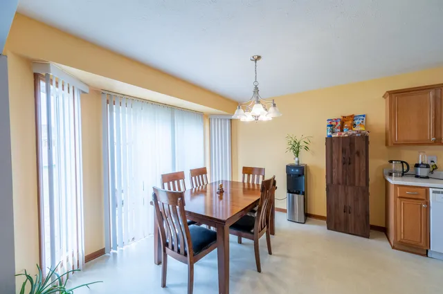 a view of a dining room with furniture and chandelier
