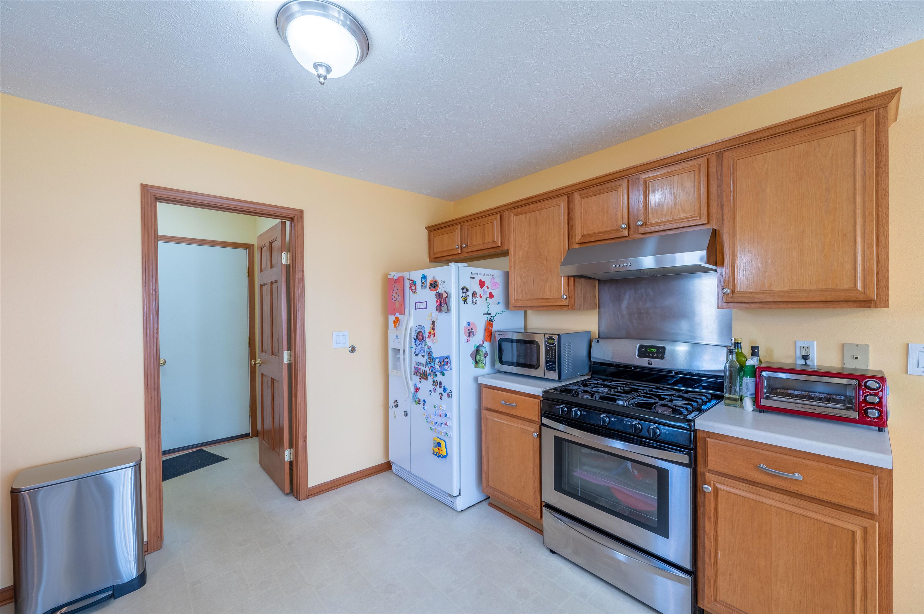 726 Golden Prairie Drive Davis Junction, IL 61020 - Photo 10 of 29 a kitchen with stainless steel appliances granite countertop a stove and a refrigerator