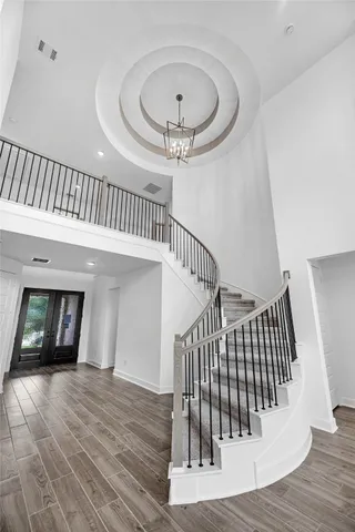 a view of entryway and hall with wooden floor