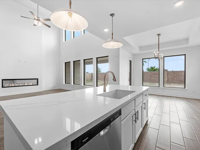 a view of a kitchen with a sink and chandelier