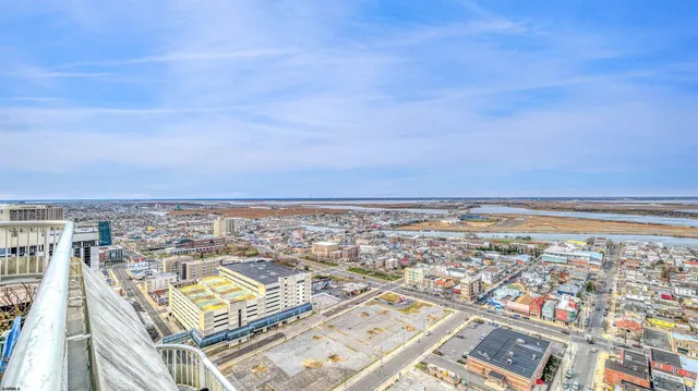 an aerial view of residential building and ocean view