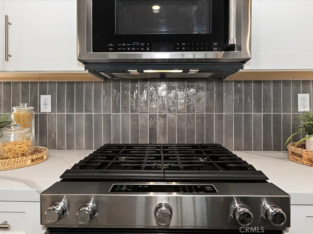 a bathroom with a sink a mirror and a potted plant