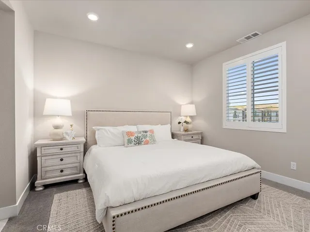 a bedroom with a bed and a dresser in it