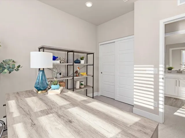 a bathroom with a sink a toilet a mirror a vanity and shower