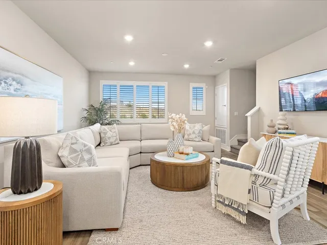 a living room with furniture kitchen and a table