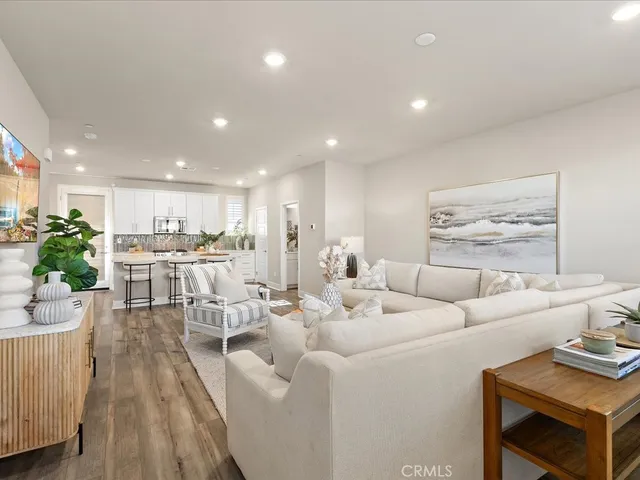 a living room with furniture kitchen view and a table