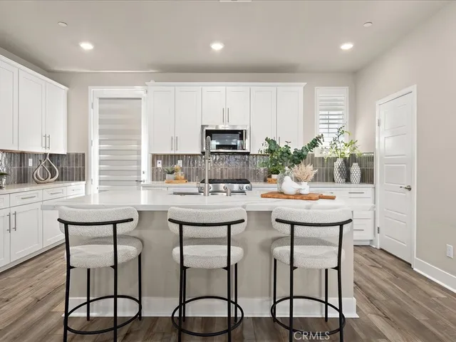 a kitchen with microwave a sink and cabinets