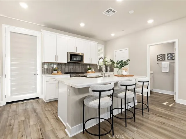 a kitchen with a sink stove and refrigerator