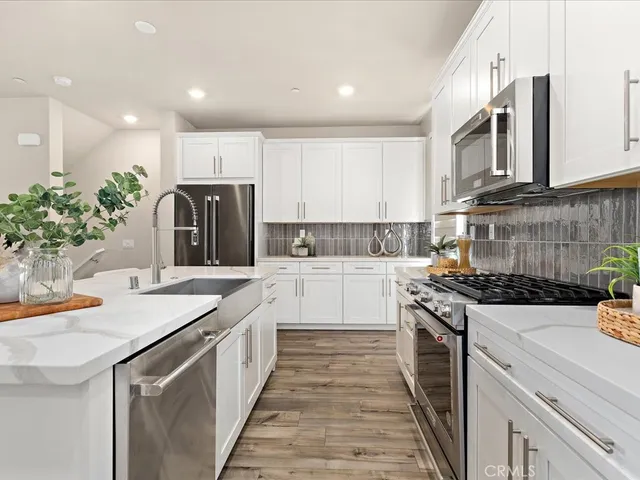 a kitchen with sink a stove and cabinets