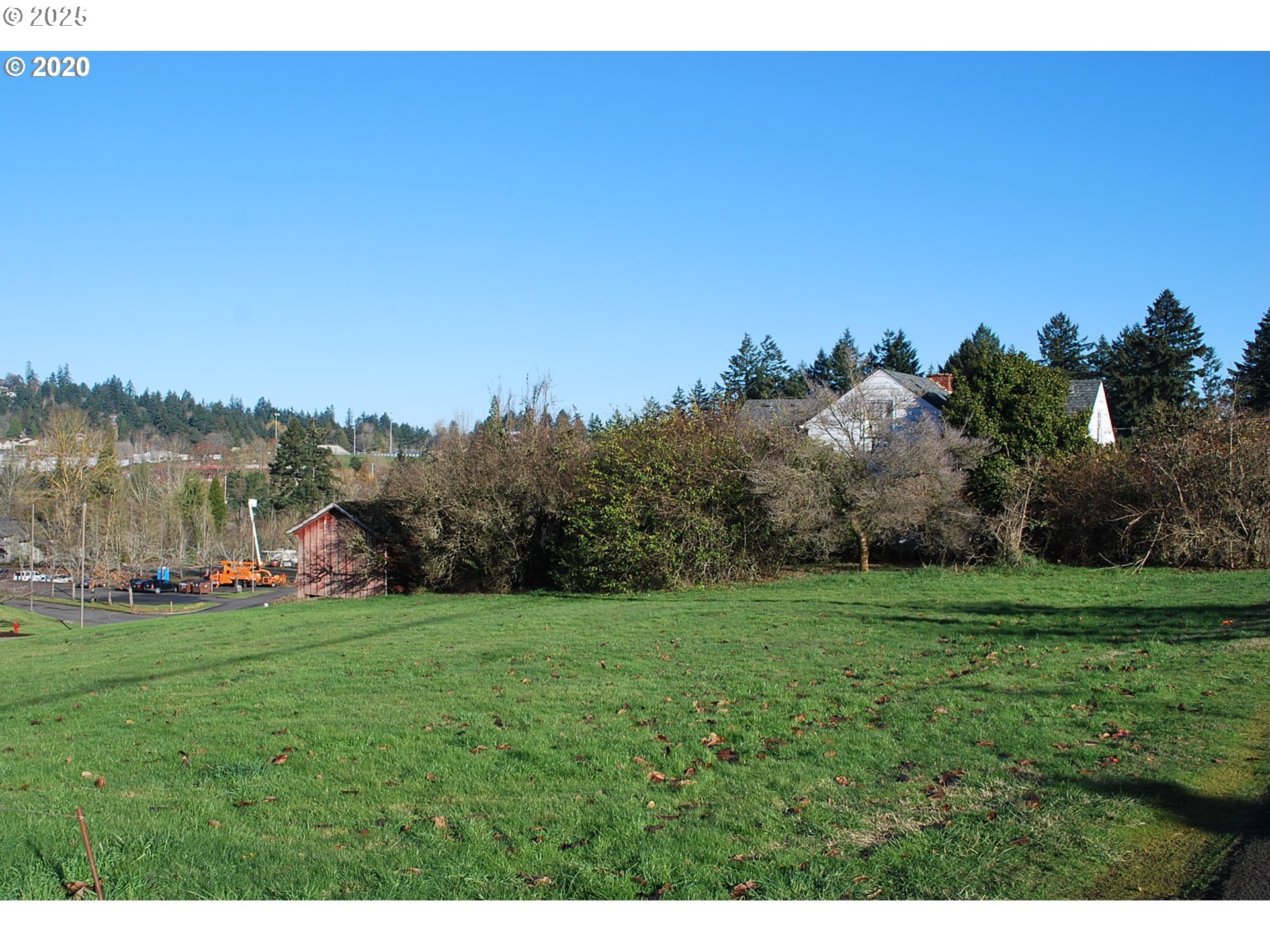 2119 Southwest Nevada Court Portland, OR 97219 - Photo 3 of 15 a view of a grassy field with trees