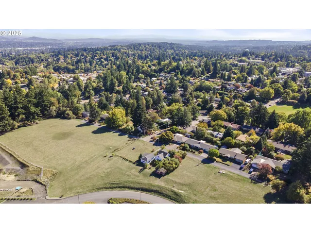 an aerial view of a house with a yard and lake view