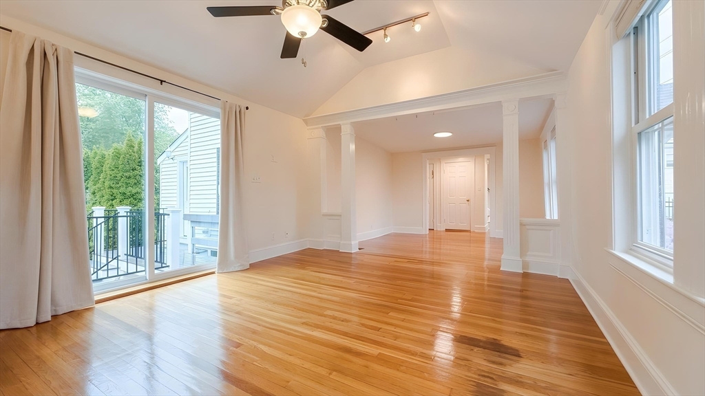 114 Curve Street Dedham, MA 02026 - Photo 5 of 27 a view of an empty room with wooden floor and a window