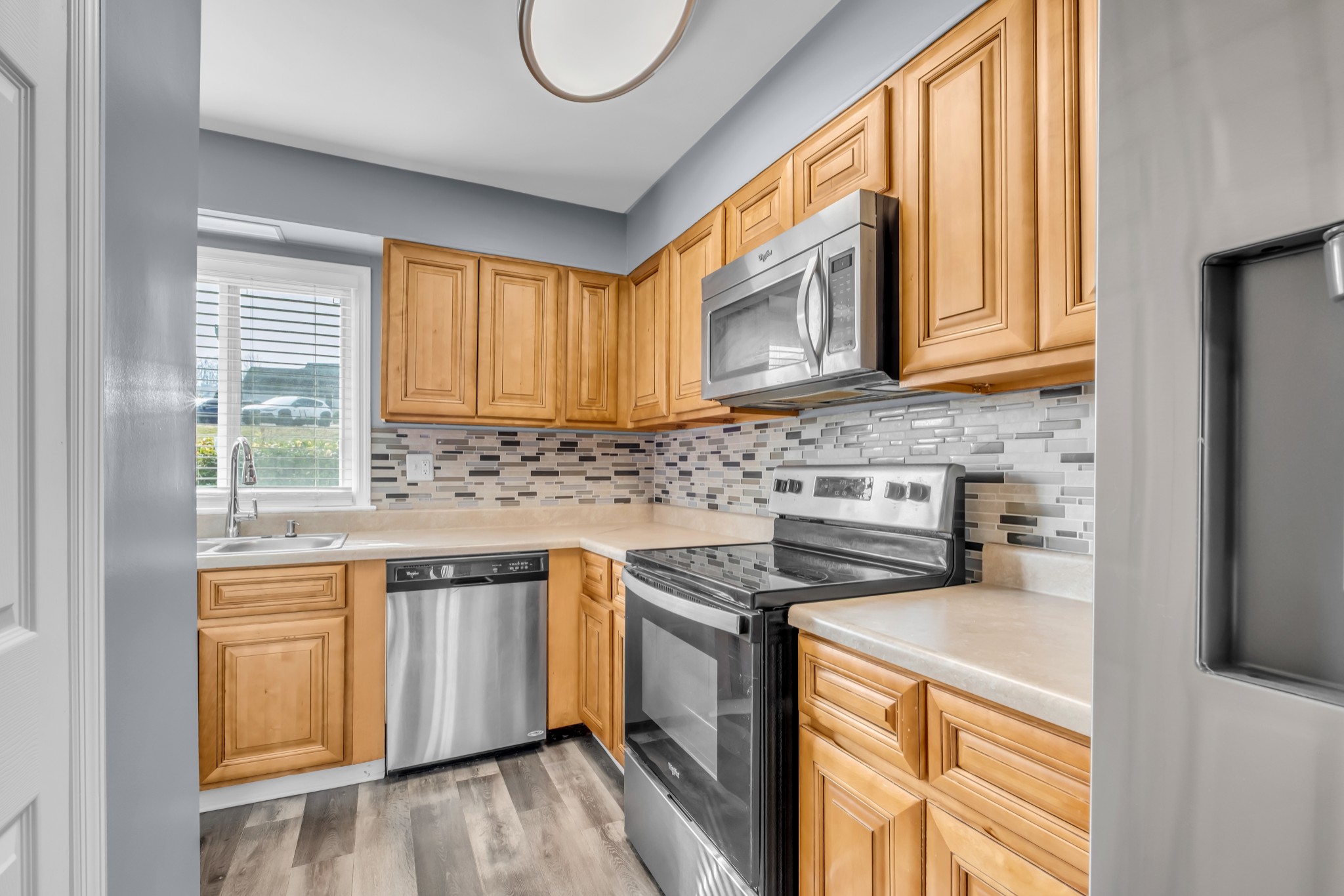 403 Raintree Drive Hermitage, TN 37076 - Photo 10 of 22 a kitchen with stainless steel appliances granite countertop a stove a sink and a microwave