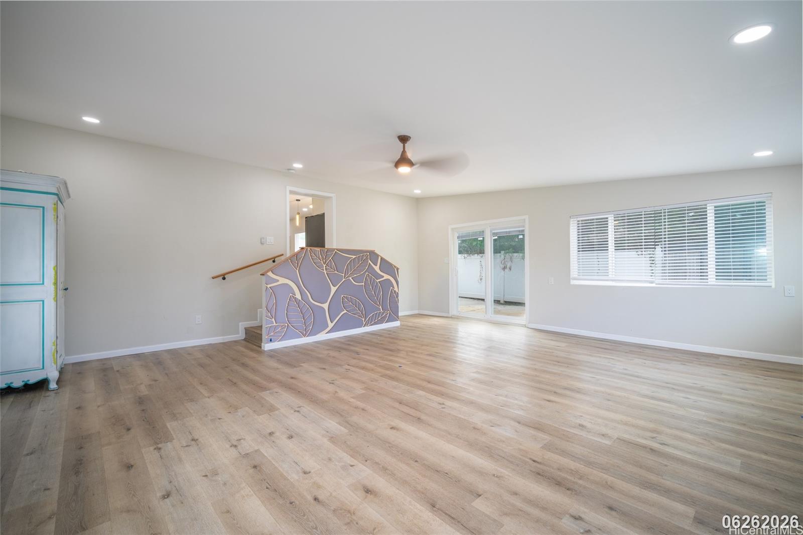87-1409 Akowai Road Waianae, HI 96792 - Photo 21 of 25 a view of an empty room with a window and wooden floor