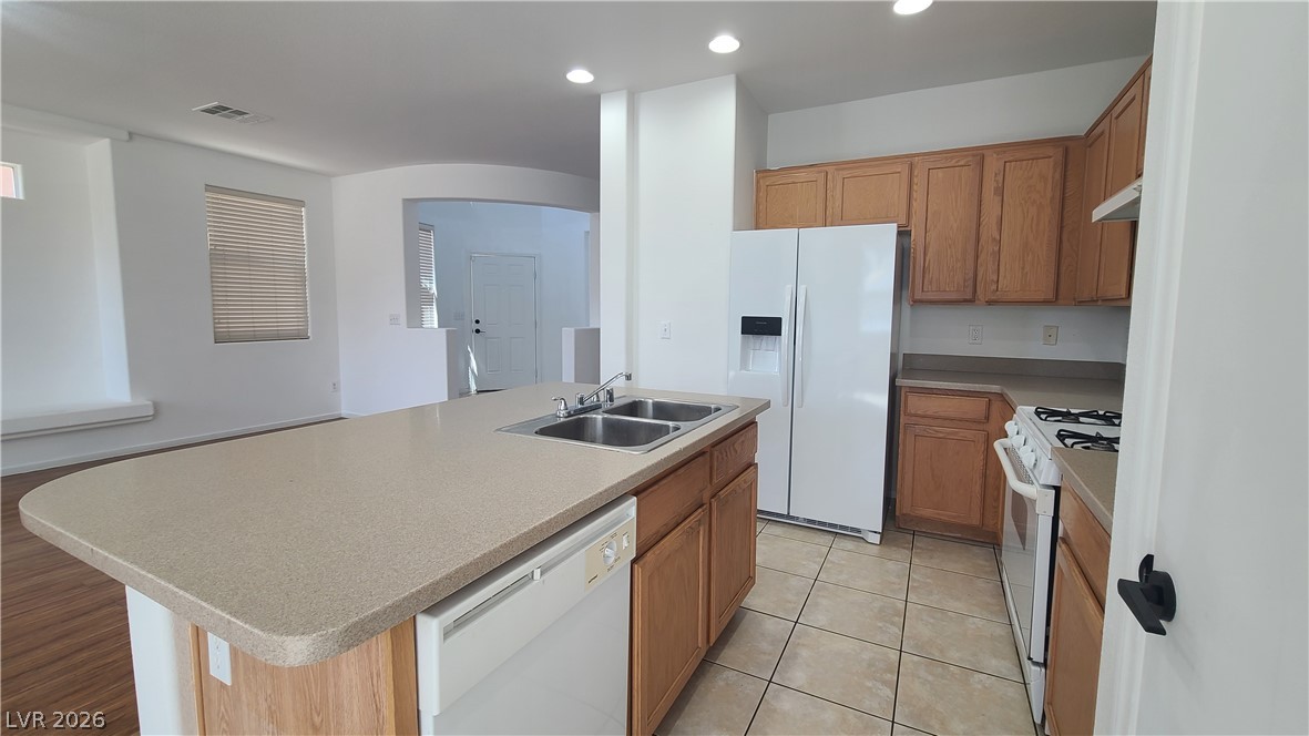 8944 Rutherford Grove Street Las Vegas, NV 89148 - Photo 8 of 35 A well-lit kitchen with ample counter space and essential appliances, perfect for everyday living.
