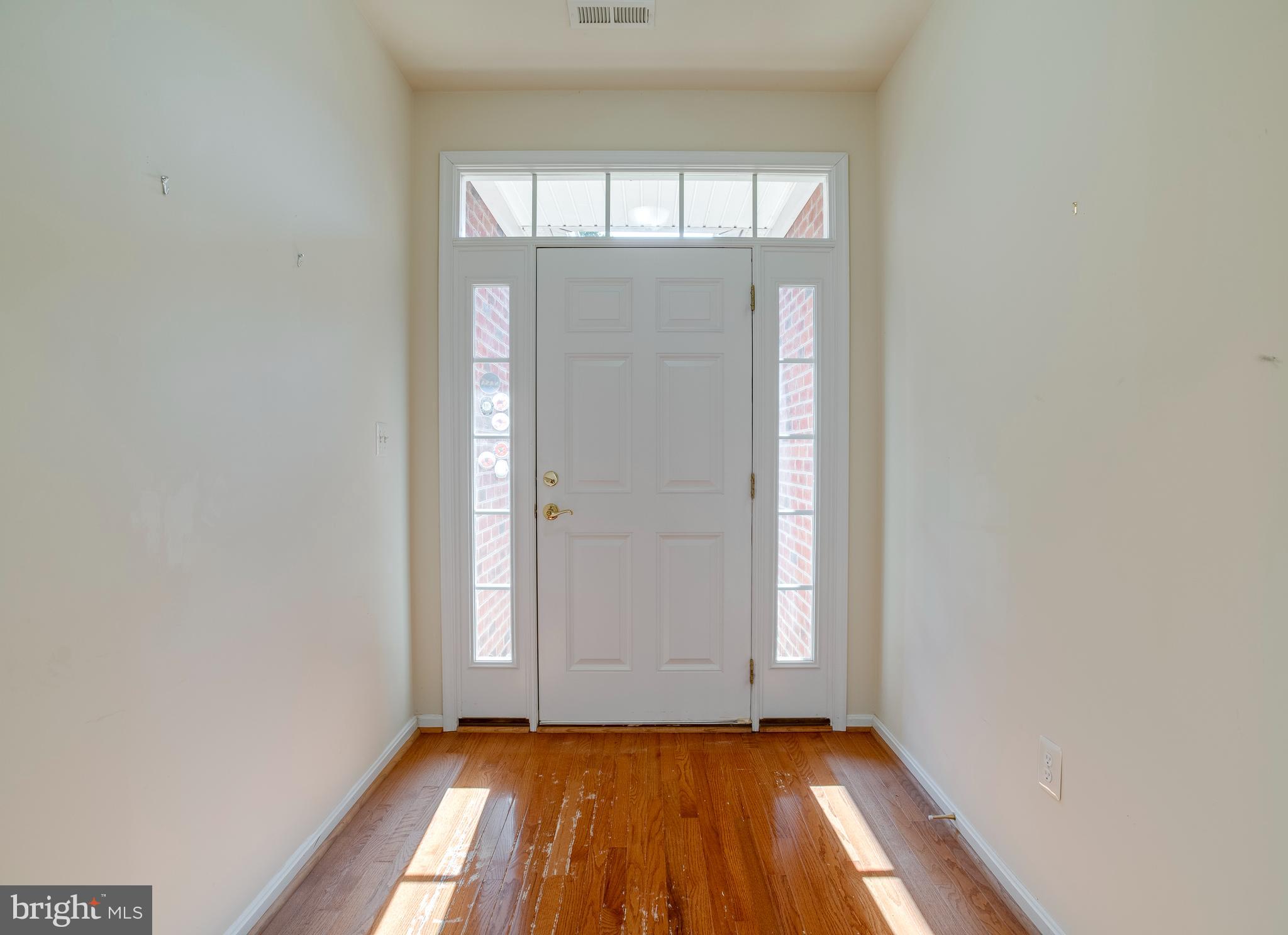 14308 South Hall Court Culpeper, VA 22701 - Photo 2 of 78 a view of an empty room with wooden floor and a window