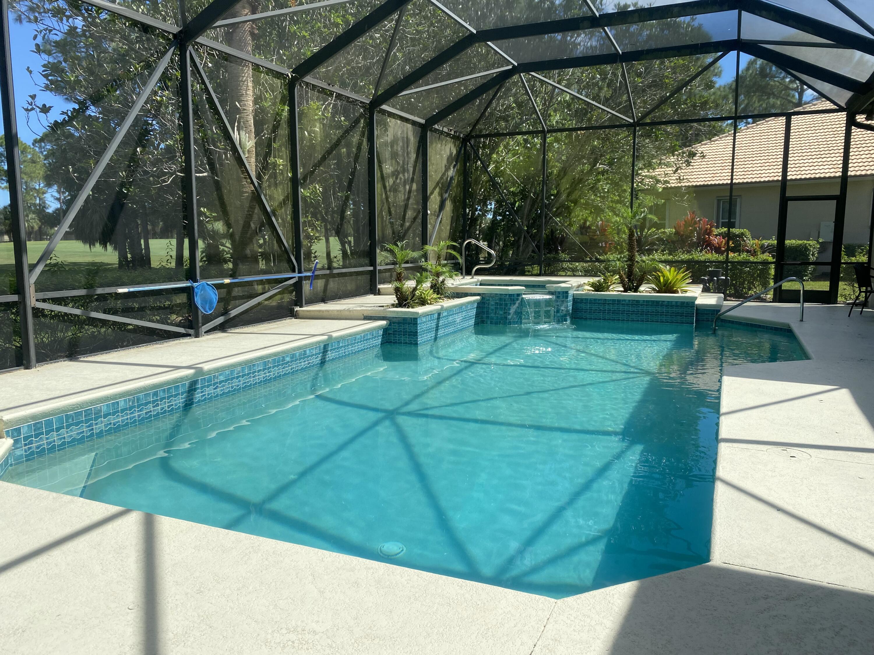 8828 Bally Bunion Road Port St. Lucie, FL 34986 - Photo 2 of 2 a view of a swimming pool with a patio
