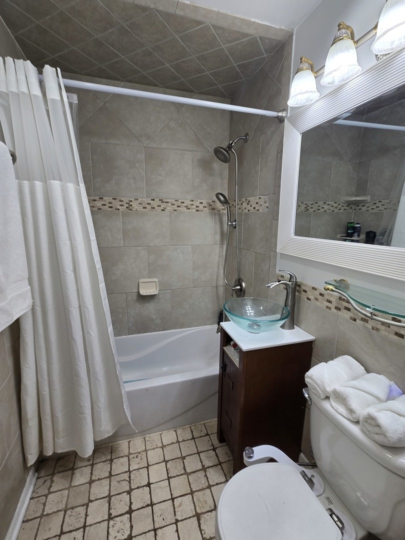 14932 Kedvale Avenue Midlothian, IL 60445 - Photo 11 of 17 a bathroom with a sink toilet and shower