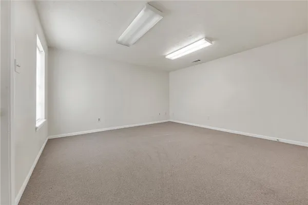an empty room with a empty space and a window
